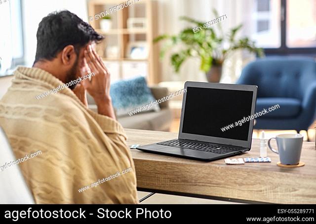 sick indian man having video call on laptop