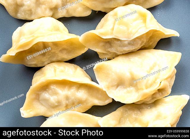 top view of cooked dumplings on gray plate close up