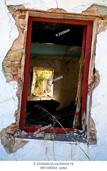 old window in destroyed house