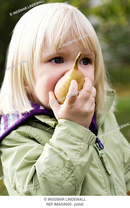 A girl eating a pear, Nacka, Sweden