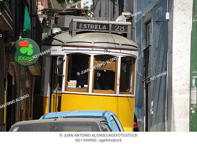 The popular tram 28 through the winding and narrow streets of Alfama. Lisbon, Portugal