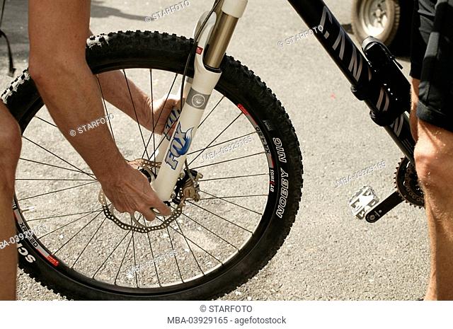 Man, hands, front-wheel, installs, tires, mountainbike