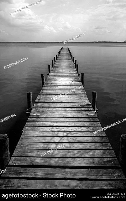 Long Wooden pier at silence lake, monochrome shoot