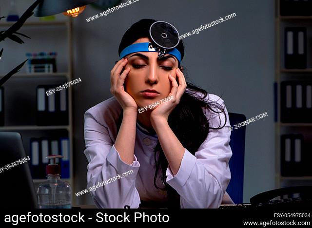 Young female doctor working at night shift