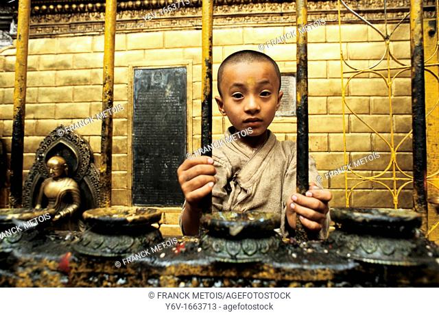 Boy working as a priest in the Golden temple at Patan  Nepal  It's a tradition among Newars, the original inhabitants of the Kathmandu valley  Every month