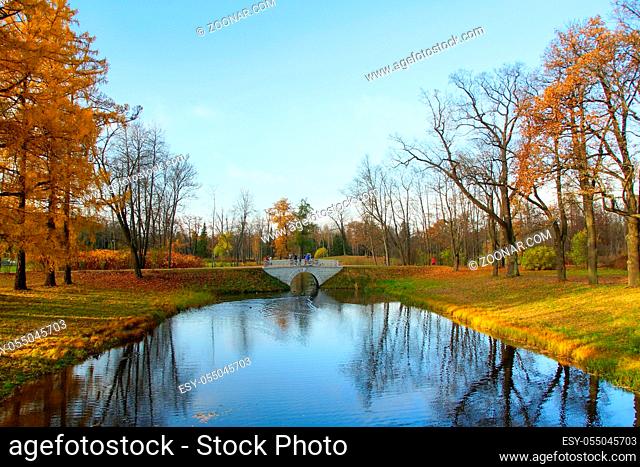 Autumn walk in Alexander Park in Tsarskoye Selo, a pond and an old bridge
