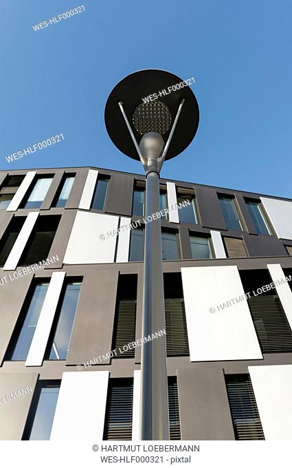 Germany, North Rhine-Westphalia, Aachen, office building and street lamp