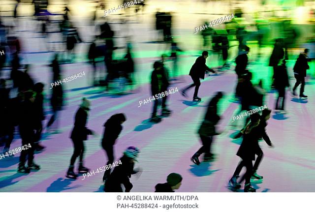 A photo taken with multiple exposure shows skaters on the ice rink in the Planeten un Blomen in Hamburg, Germany, 04 January 2014