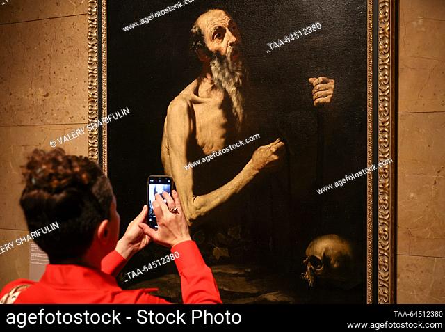 RUSSIA, MOSCOW - NOVEMBER 7, 2023: A woman takes a picture of St Onuphrius (circa 1650) by Spanish artist Jusepe de Ribera during a press preview of an...