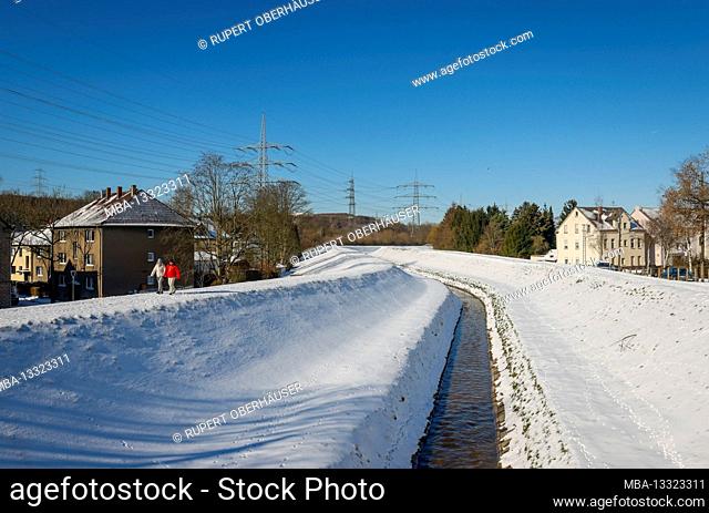 Bochum, North Rhine-Westphalia, Germany - Sunny winter landscape in the Ruhr area, ice and snow on the Hüller Bach, the brook is being transformed into a...