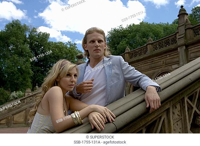 Young couple leaning against a bannister, Central Park, Manhattan, New York City, New York, USA