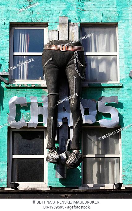 Colourfully decorated facade featuring legs in jeans at Camden Market, Camden Town, London, England, United Kingdom, Europe