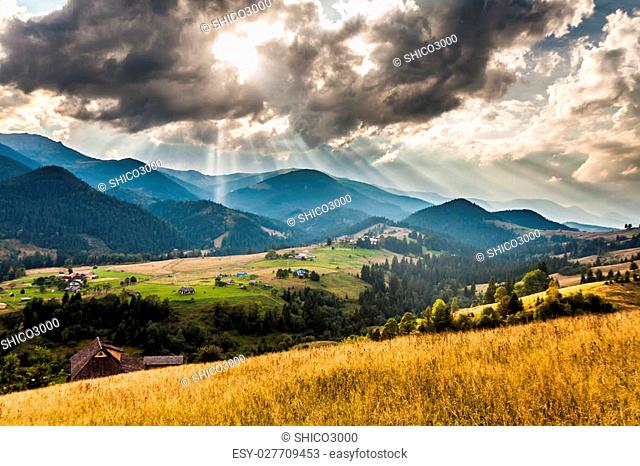 Beautiful light beam in morning with village on mountain valleys