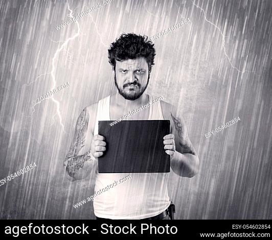 Caught gangster with rainy, grey background and black table on his hand