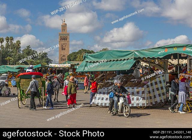 Stalls on Jemaa el Fna (Djemaa el Fnaa) Square, UNESCO World Heritage Site & Koutoubia Mosque visible, Marrakesh (Marrakech), Morocco, North Africa, Africa