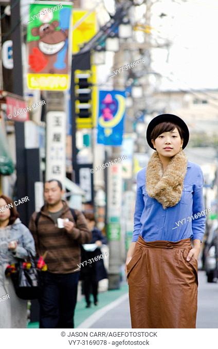 Japanese Girl poses on the street in Shimo-Kitazawa, Japan. Shimo-Kitazawa is a town located in Tokyo