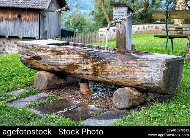 FIE ALLO SCILIAR, SOUTH TYROL/ITALY - AUGUST 8 : View of a wooden drinking water trough in Fie allo Sciliar, South Tyrol, Italy on August 8, 2020
