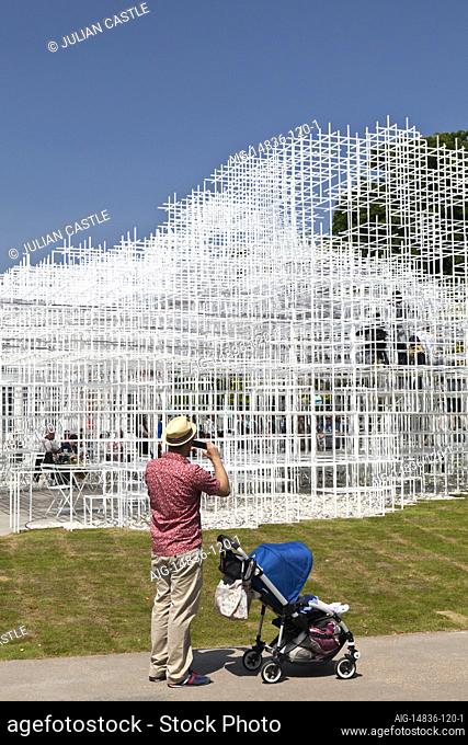A visitor takes a picture of the Serpentine Pavilion 2013, Kensington Gardens, London, W2, England