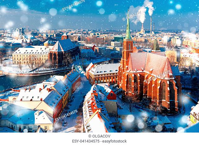 Aerial view of Ostrow Tumski with church of the Holy Cross and St. Bartholomew from Cathedral of St. John in the winter snowy morning in Wroclaw, Poland