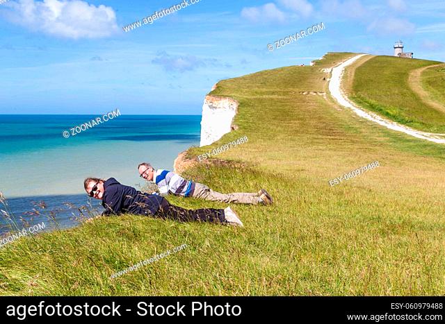Seven Sisters National Park, Man and woman looking down from the white cliffs , near Eastbourne, East Sussex, England