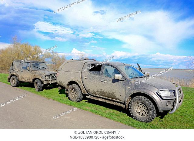 Two mud-caked cars on Lake Tisza Tisza of Tó Hungary