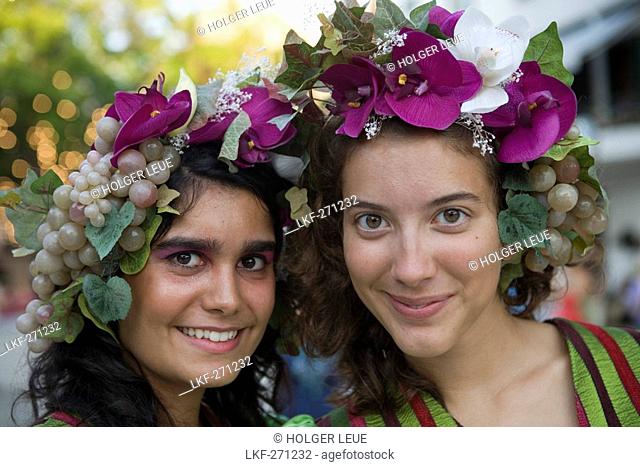 Two young women in colourful costumes at the Madeira Wine Festival, Funchal, Madeira, Portugal
