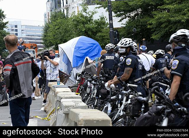 Demonstrators with Occupy H Street remove tents from Black Lives Matter Plaza in Washington D.C., U.S., on Saturday, July 4, 2020