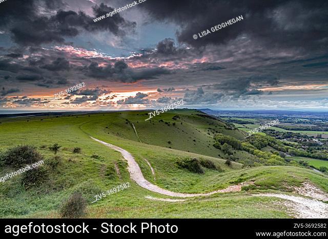 Scattered clouds over the Fulking village and views towards truleigh hiill and the sea on the South Downs National Park from Devil's Dyke, Sussex, England