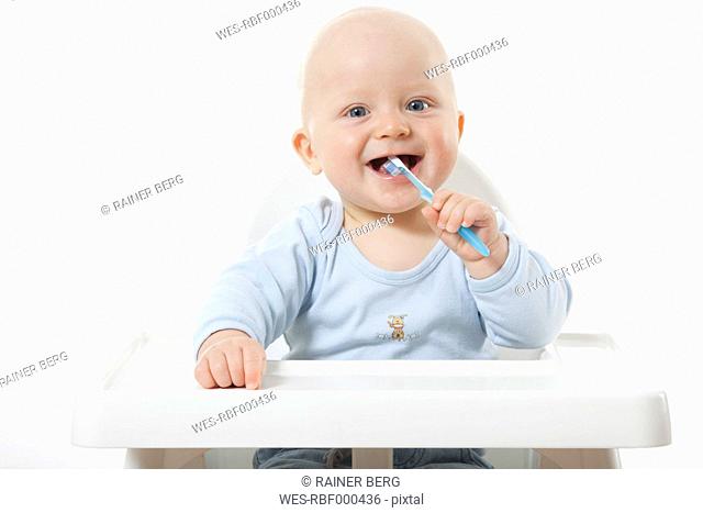 Baby boy 6- 11 Months brushing teeth, smiling, portrait