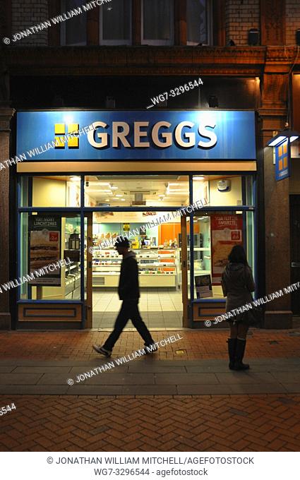 READING, ENGLAND, UK - November 13: Shoppers and passers by outside a Greggs bakery shop in Queen Victoria Street Reading England UK on November 13, 2013