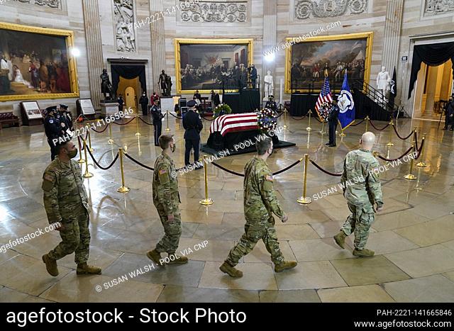 Members of the National Guard walk past the casket of slain U.S. Capitol Police officer William “Billy” Evans as he lies in honor at the Capitol in Washington