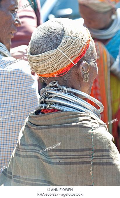 Bonda tribeswoman wearing shawl over traditional bead costume, with beaded cap and metal necklaces at weekly market, Rayagader, Orissa, India, Asia