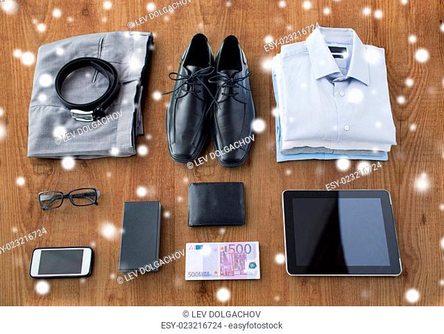 business, style, clothes and objects concept - close up of formal male clothes and personal stuff on wooden table at home over snow effect