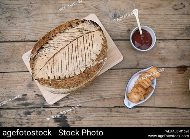 Bread with sauce and crackers down on table