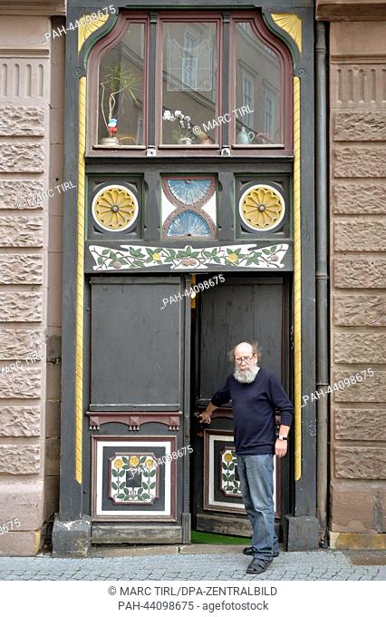 Klaus Trippstein, resident and owner of the 'Narrow House', poses in front of his house in Eisenach, Germany, 07 November 2013. With a width of 2