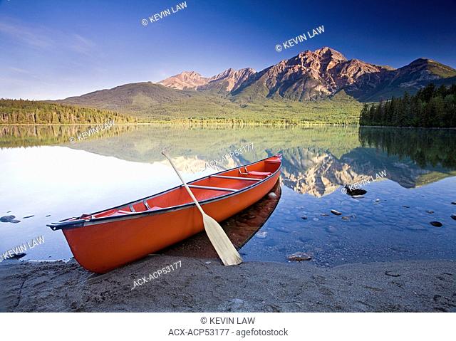 Red canoe on shore at Pyramid Lake, Jasper National Park, Alberta, Canada