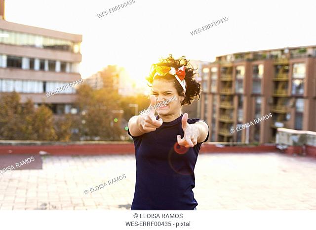 Portrait of young woman having fun in the city at sunset