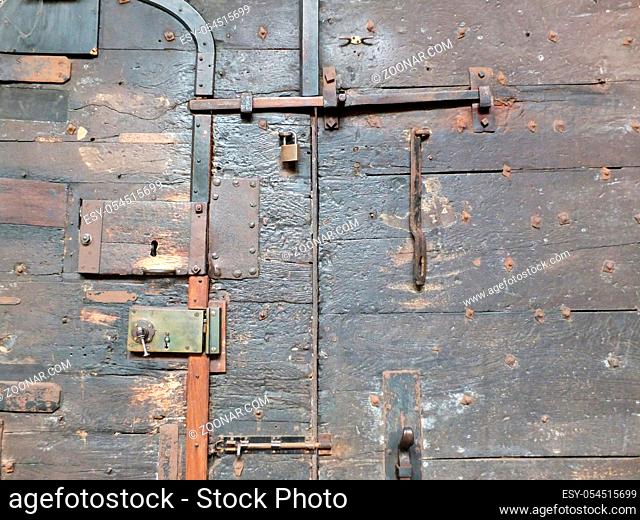 ancient black wooden medieval door with iron locks and bolts on chester cathedral