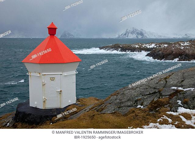 Lighthouse on the rocky coast of Henningsvaer, Austvagoy island, Lofoten, Norway, Europe