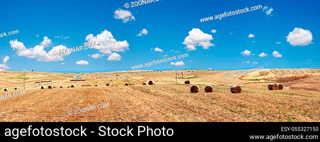 Beautiful landscape of Sicily summer countryside in Italy. Wheat field with haystacks. Four shots stitch high-resolution panorama