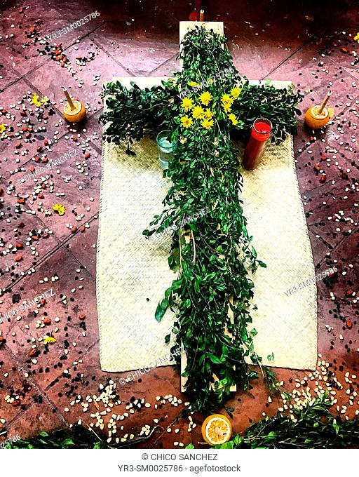A green cross decorates an altar during Dia de Muertos in Coyoacan, Mexico