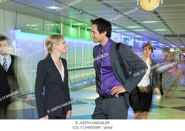 business couple at airport, talking