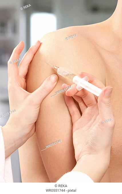 Man getting injection in upper arm