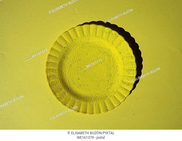 Yellow plate on yellow background