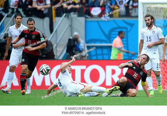 Germany's Miroslav Klose (L) and Philipp Lahm (2R) vie for the ball with Michael Bradley (C) of the US and Kyle Beckerman of the US during the FIFA World Cup...