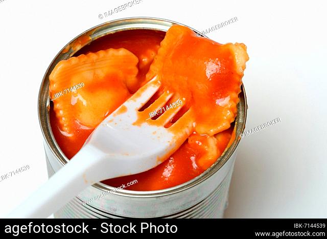 Ravioli in tin and plastic fork, ready meal with fork