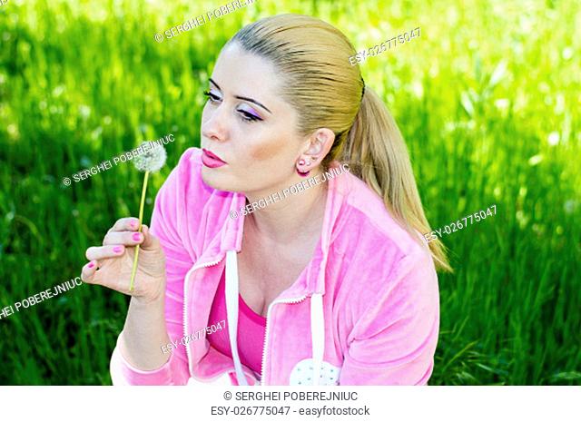 the woman in a pink suit blows on a dandelion, a subject nature seasons, spring and beautiful women