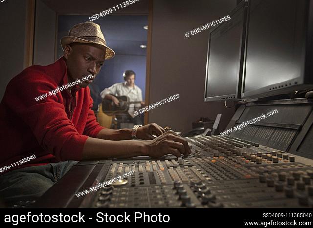 African American man working at audio control panel