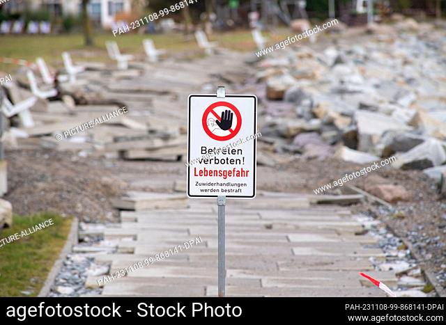 08 November 2023, Mecklenburg-Western Pomerania, Sassnitz: Sidewalk slabs were washed away by the storm surge on the Baltic Sea coast on the beach promenade on...