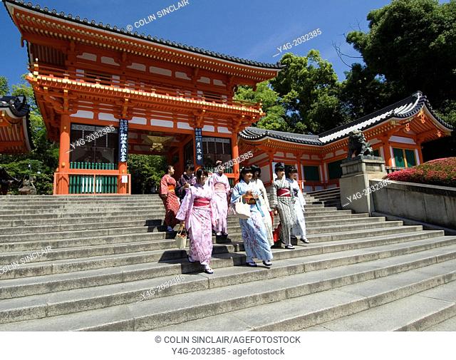 Yasaka Shrine, Maruyama Park, Near Gion, Kyoto, Japan, Schoolgirls in kimonos descending steps of main gateway into Shrine. All very happy